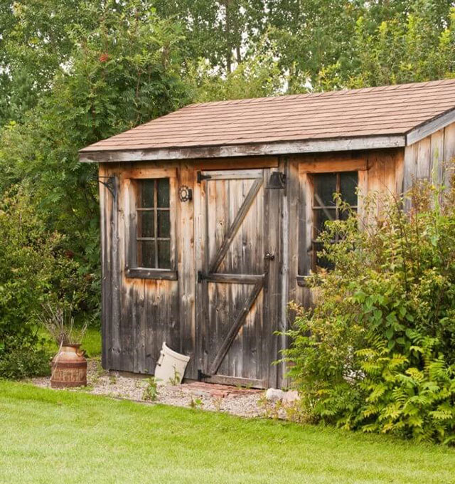 An old wooden shed in a backyard for shed removal