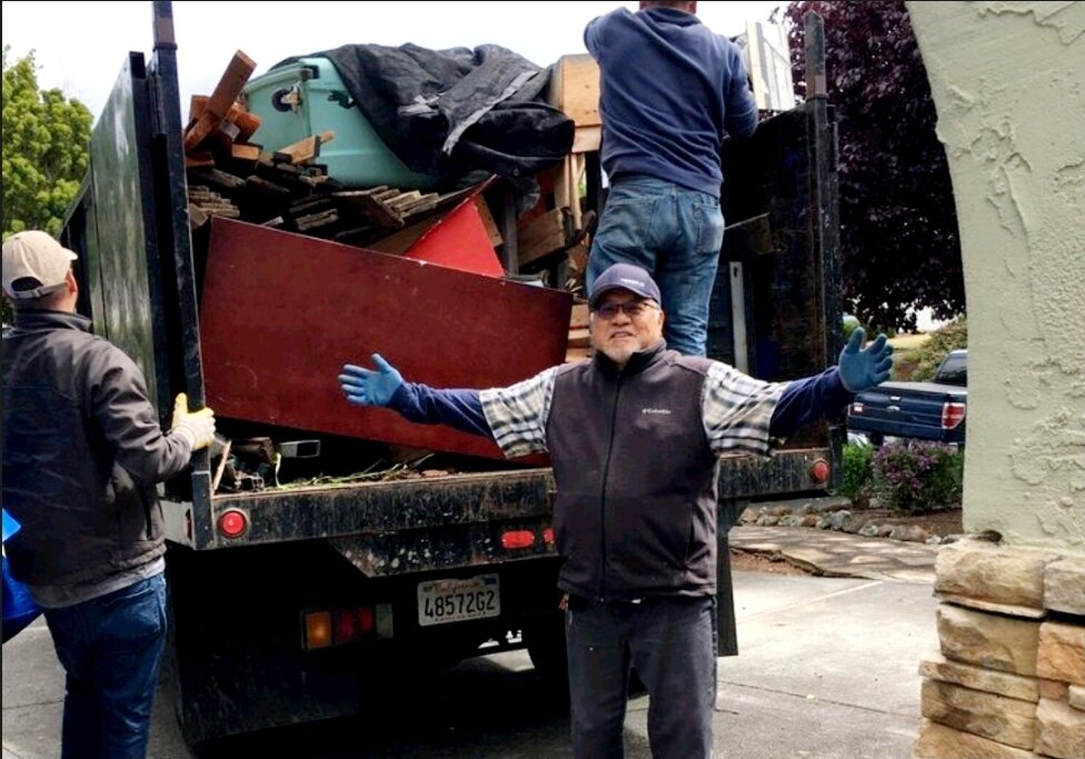 trusted man with open arms with a junk removal company