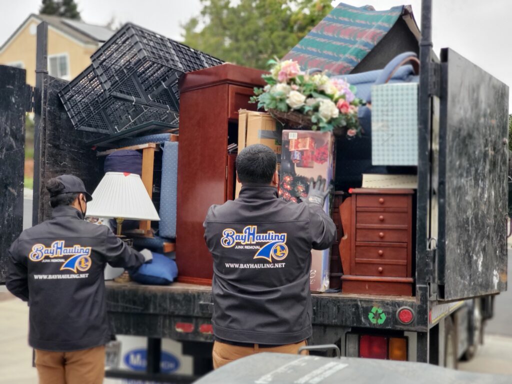 about us Bay Hauling professionals loading old furniture and junk onto the truck during junk removal services in the bay area