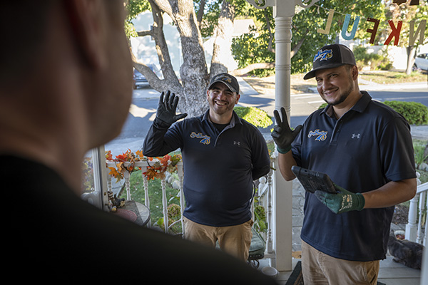 Bay Hauling Junk Removal professionals greeting a customer at the door for mattress removal services in Vallejo