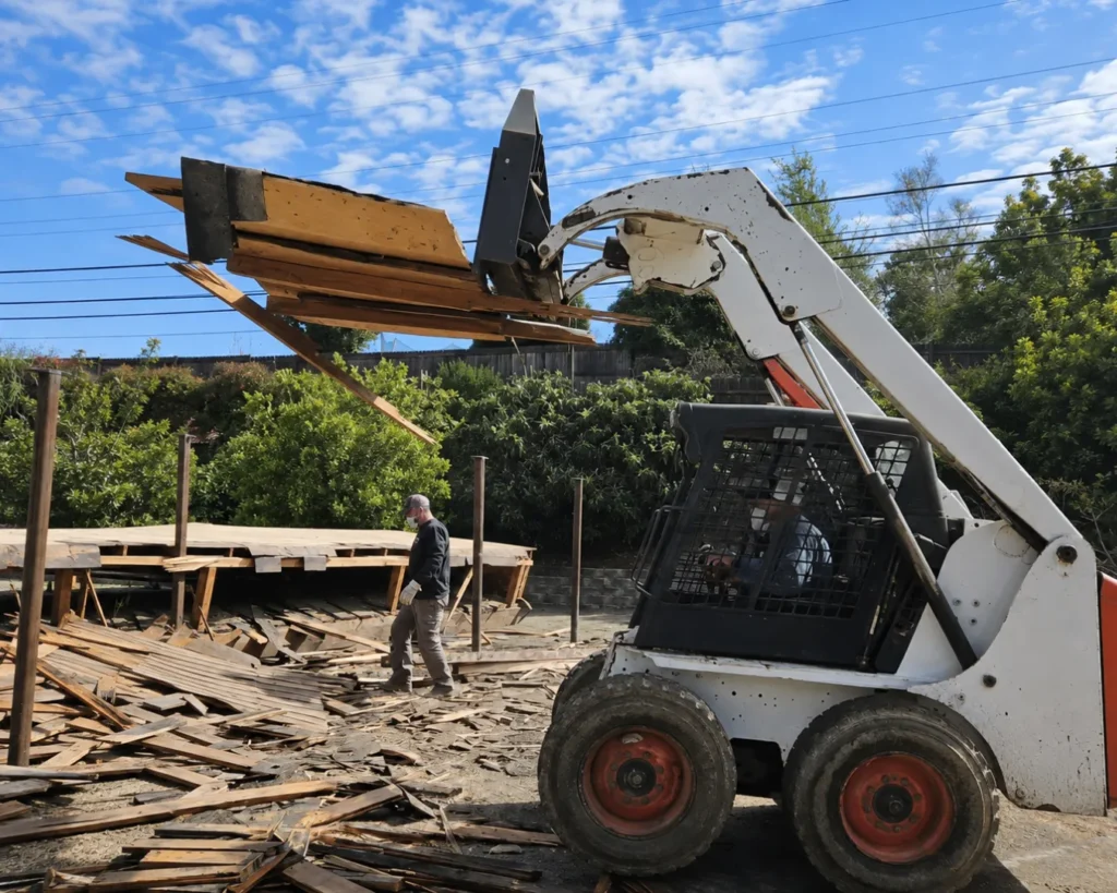 Demolition and Debris Removal crew clearing construction waste from a property